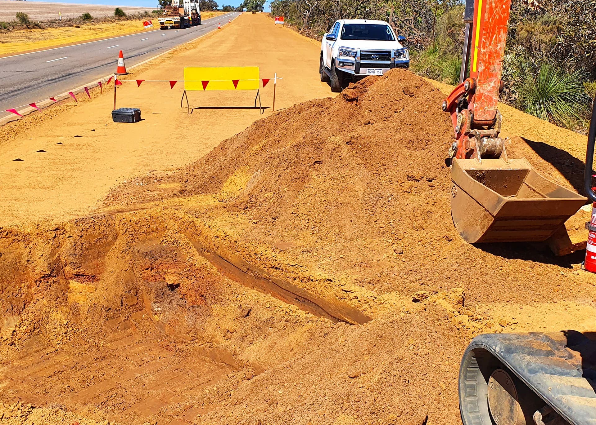 Excavated culvert extension beside the live Brand Highway with traffic management in place