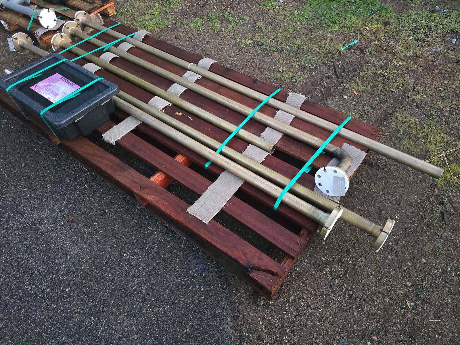 Copper nickel pipe spools with flanged risers strapped to a timber pallet for delivery