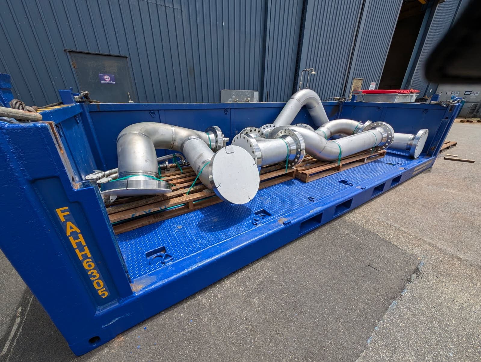 Flanged duplex pipe spools strapped into a shipping frame at the Benang yard