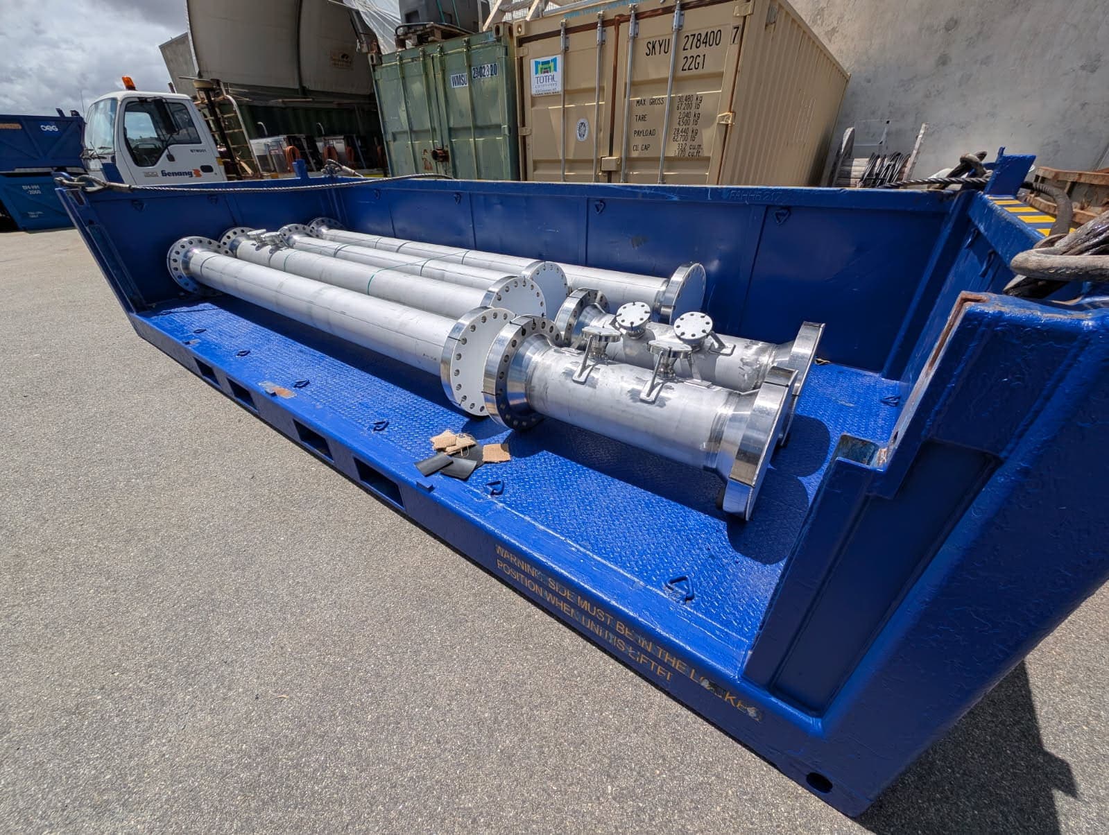 Stainless pipe spools braced in a blue offshore transport frame