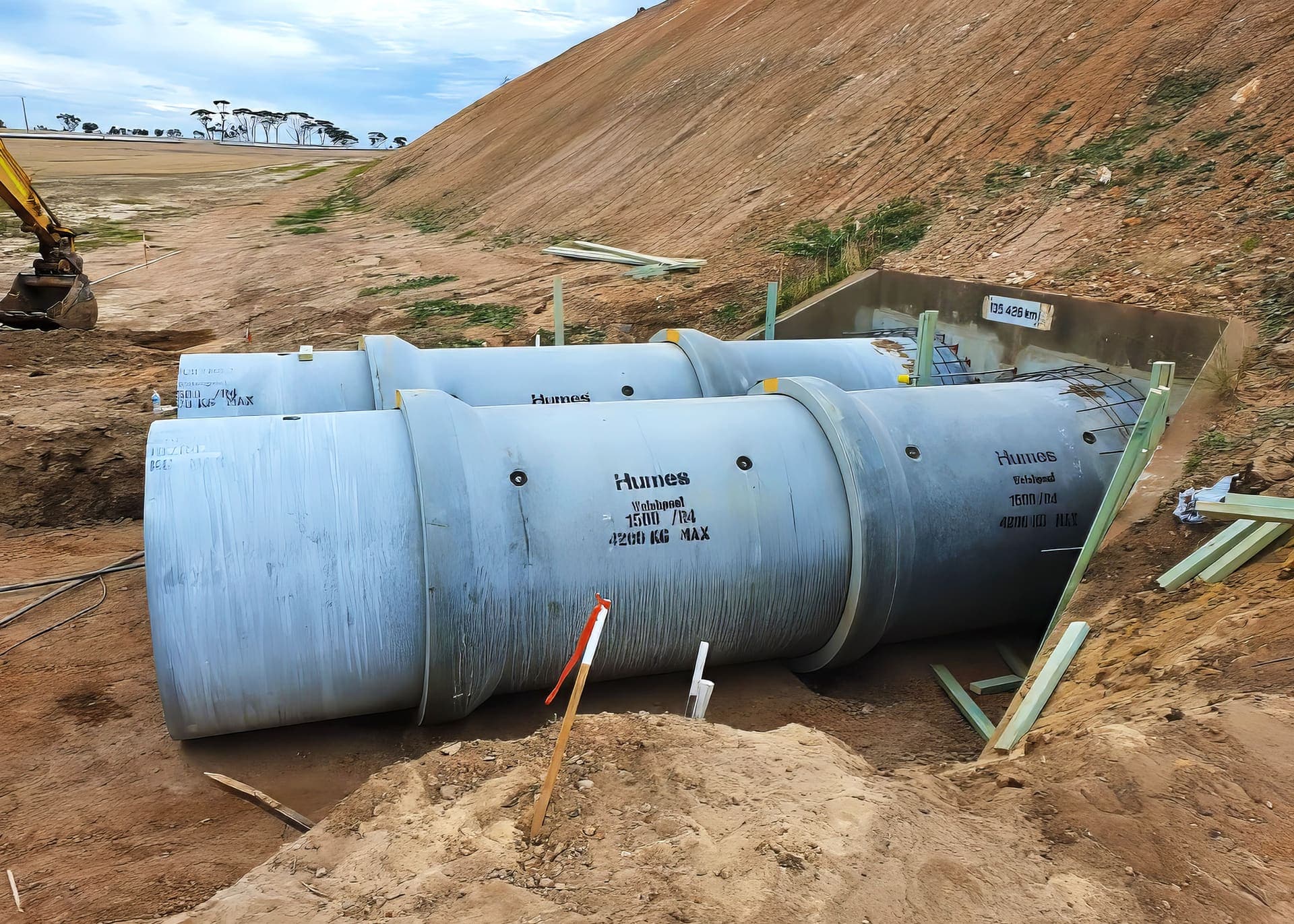 Twin concrete culvert barrels laid against the headwall at the rail embankment at Grass Valley