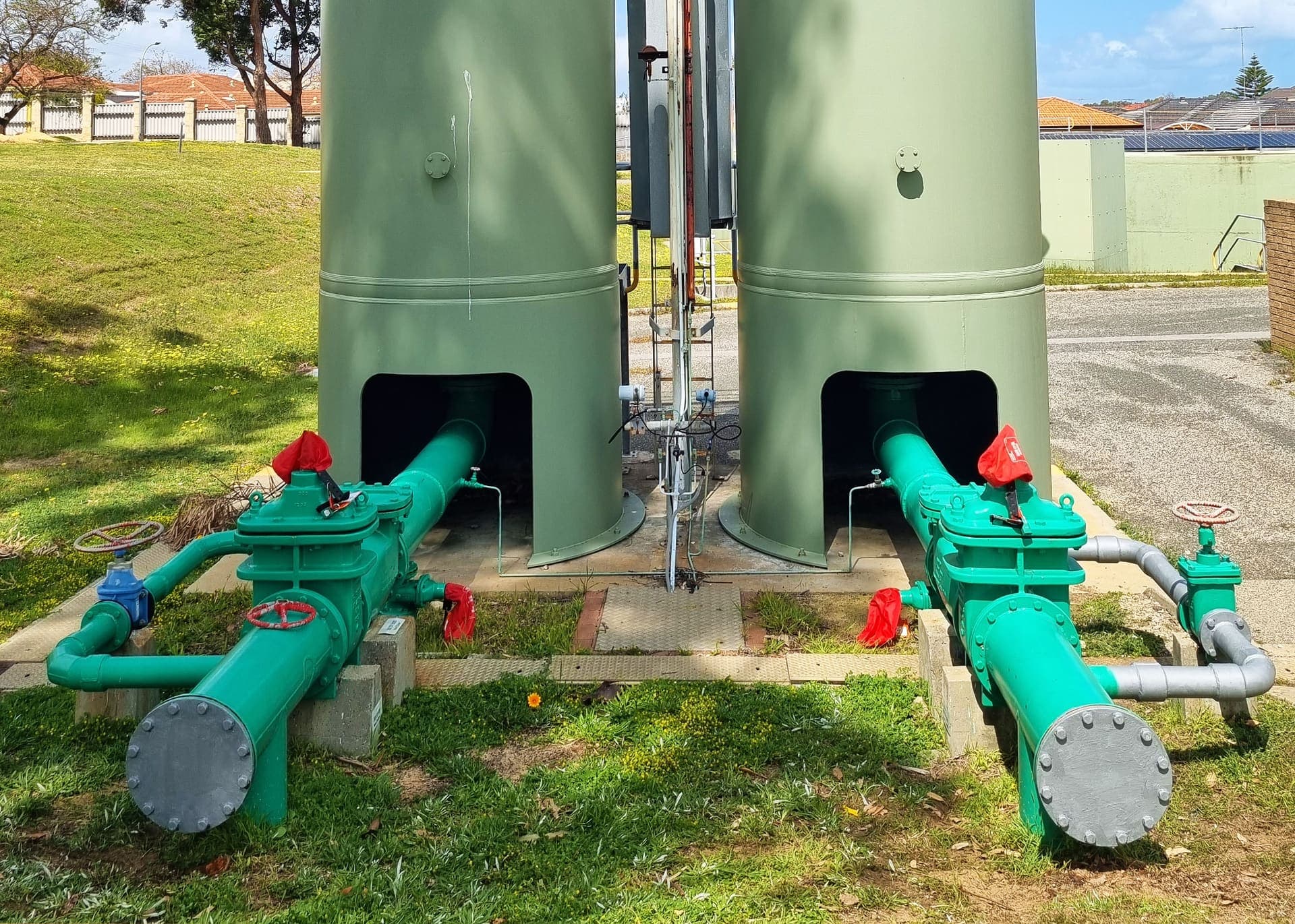 Twin surge vessels with the new green DN100 MSCL bypass pipework and valves at Gwelup