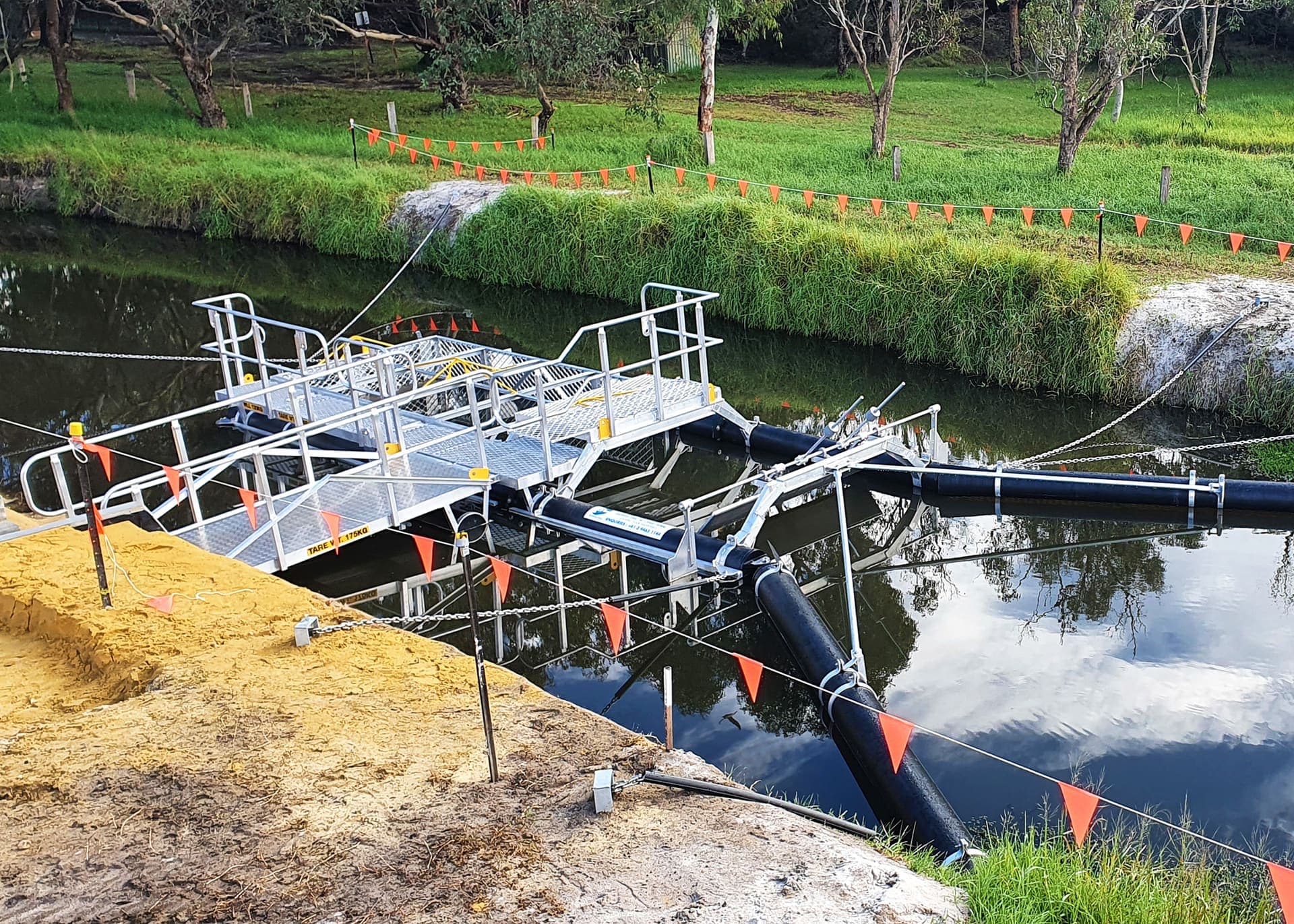 Benang crew working over the water on the litter boom installation at Herdsman Lake