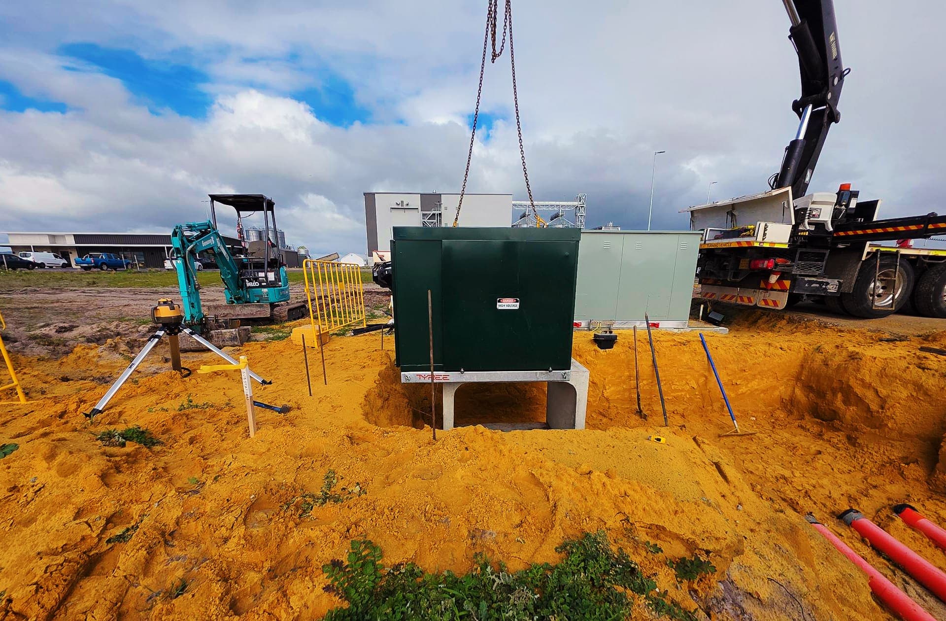 A green high voltage kiosk substation being craned onto its concrete plinth at Morley Road, Bullsbrook