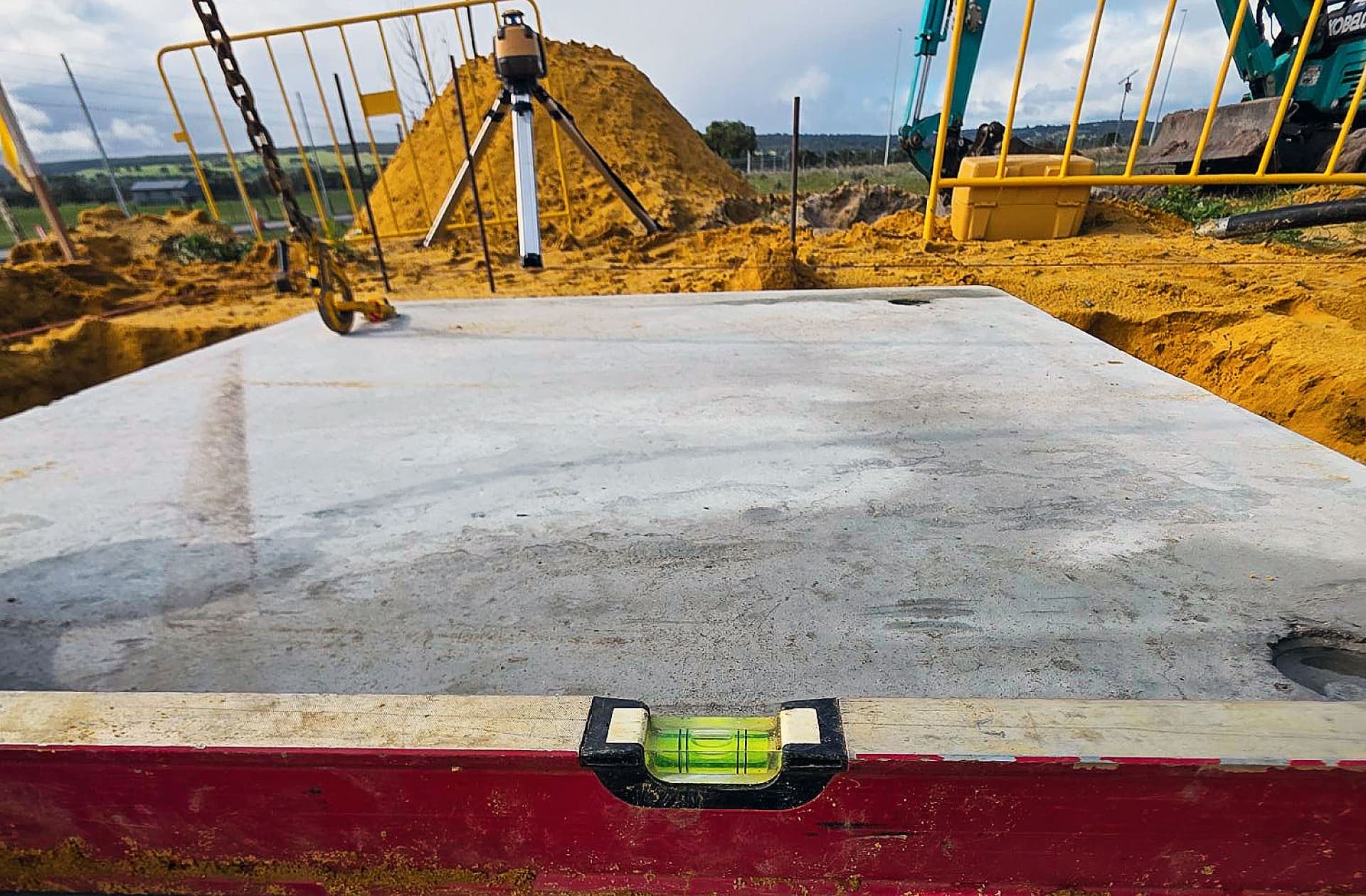 Freshly poured concrete plinth checked level with a spirit level at the Bullsbrook site