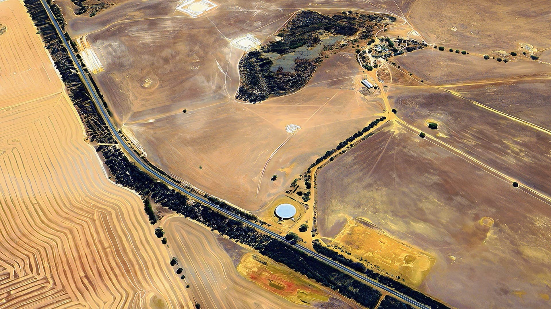 Aerial view of the North Lake Grace tank site and fill point beside the highway among wheatbelt paddocks