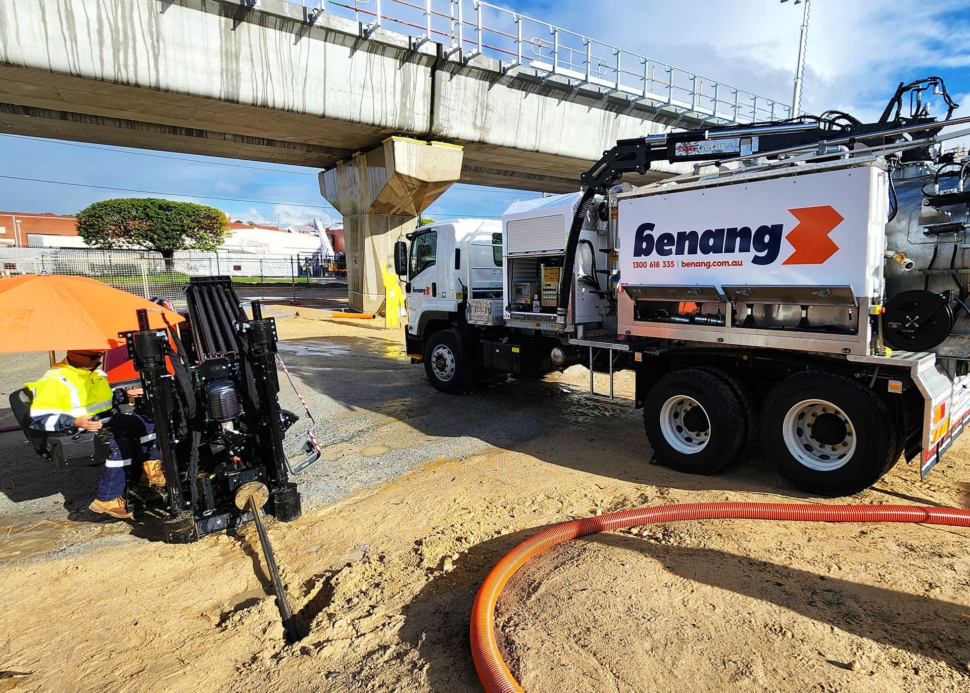 Benang vac truck and directional drilling rig set up under a rail overpass on the Western Power network support works