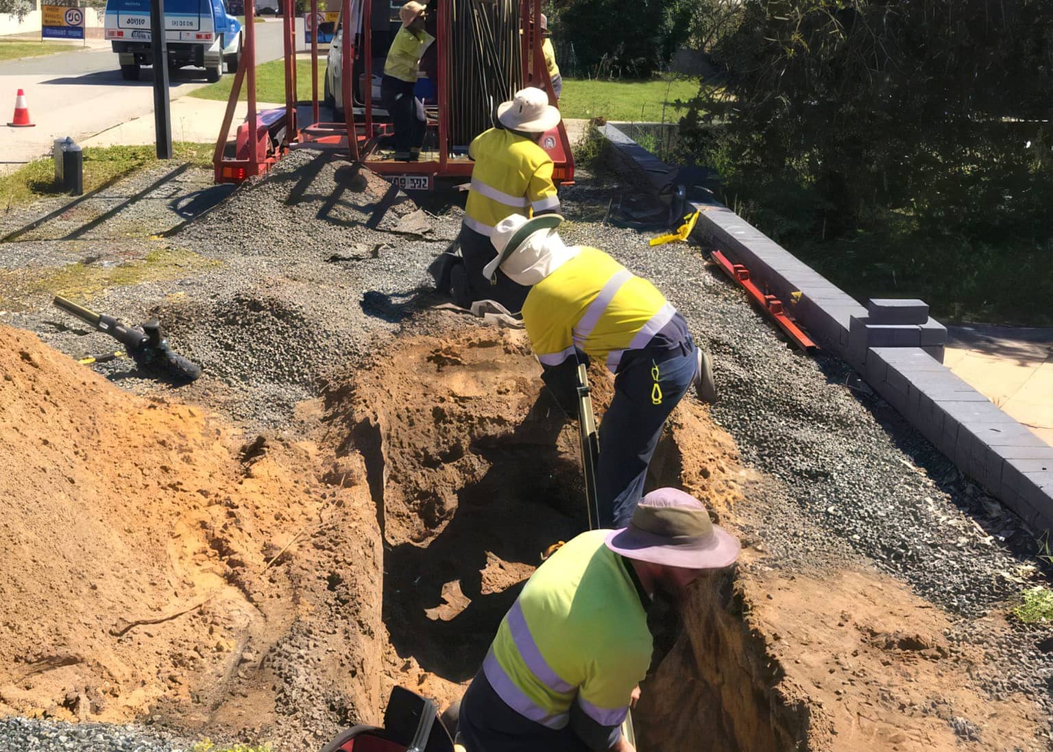 Crew backfilling around the renewed gas main