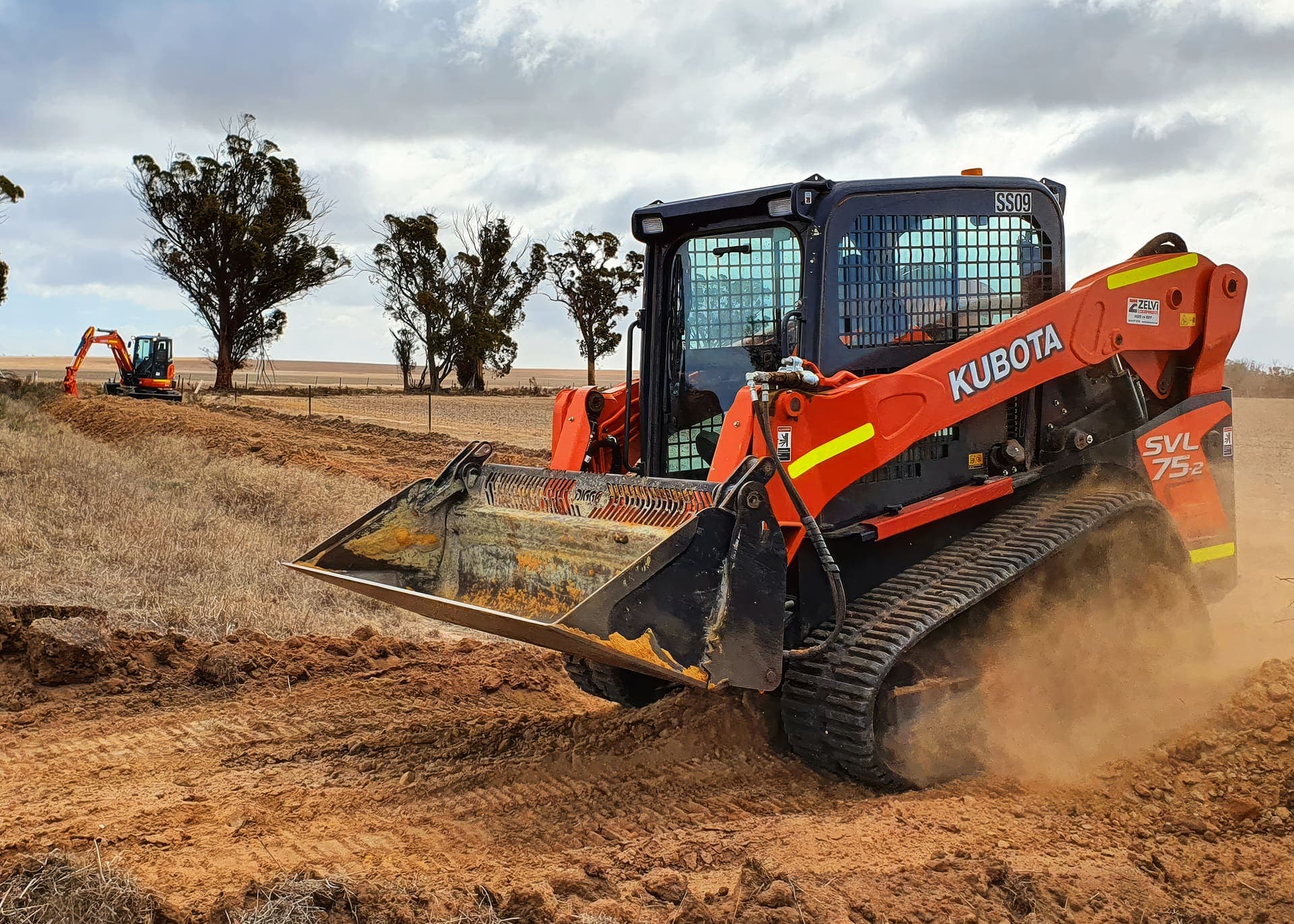 Kubota posi-track spreading backfill along the new main alignment on farmland at Babakin