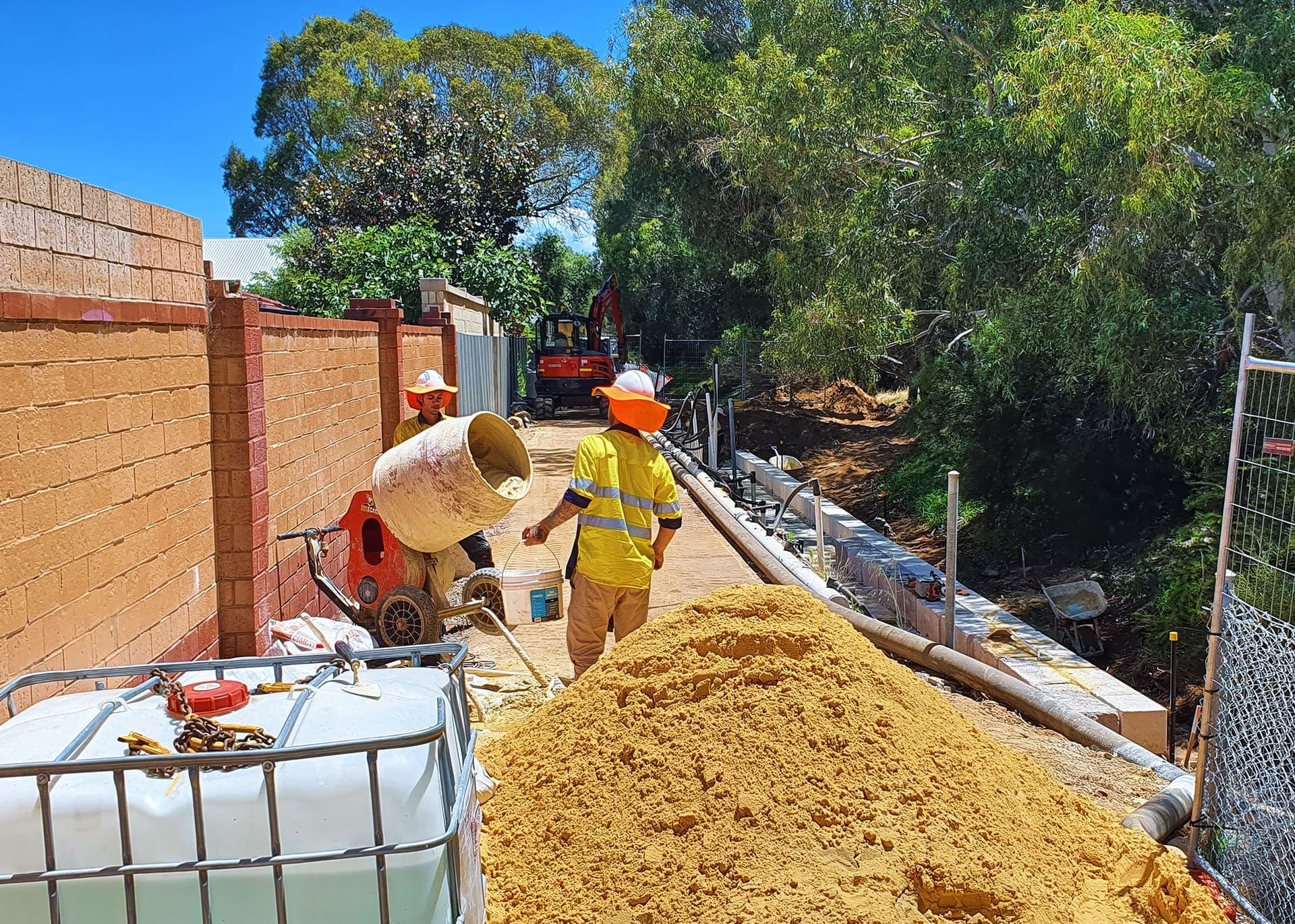 Crew placing panels between the drain wall posts