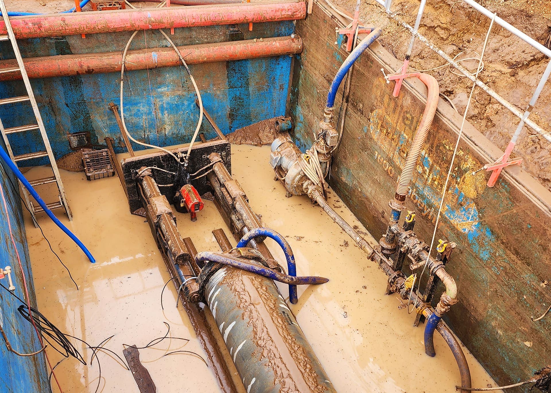 Pipe jacks, pumps and valve manifold inside the shored pit on the Narembeen main