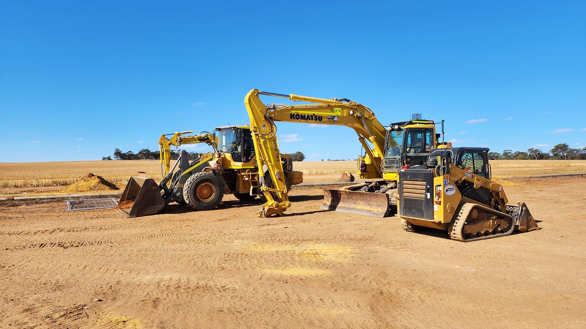 Benang loader, excavator and posi-track staged on the cleared site at Narembeen