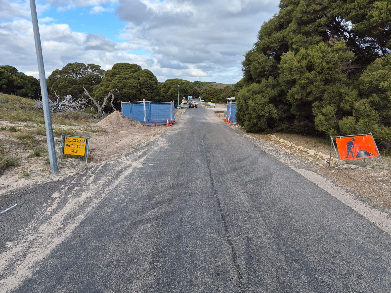 Roadside directional drilling site with barrier fencing and pedestrian signage on Rottnest Island