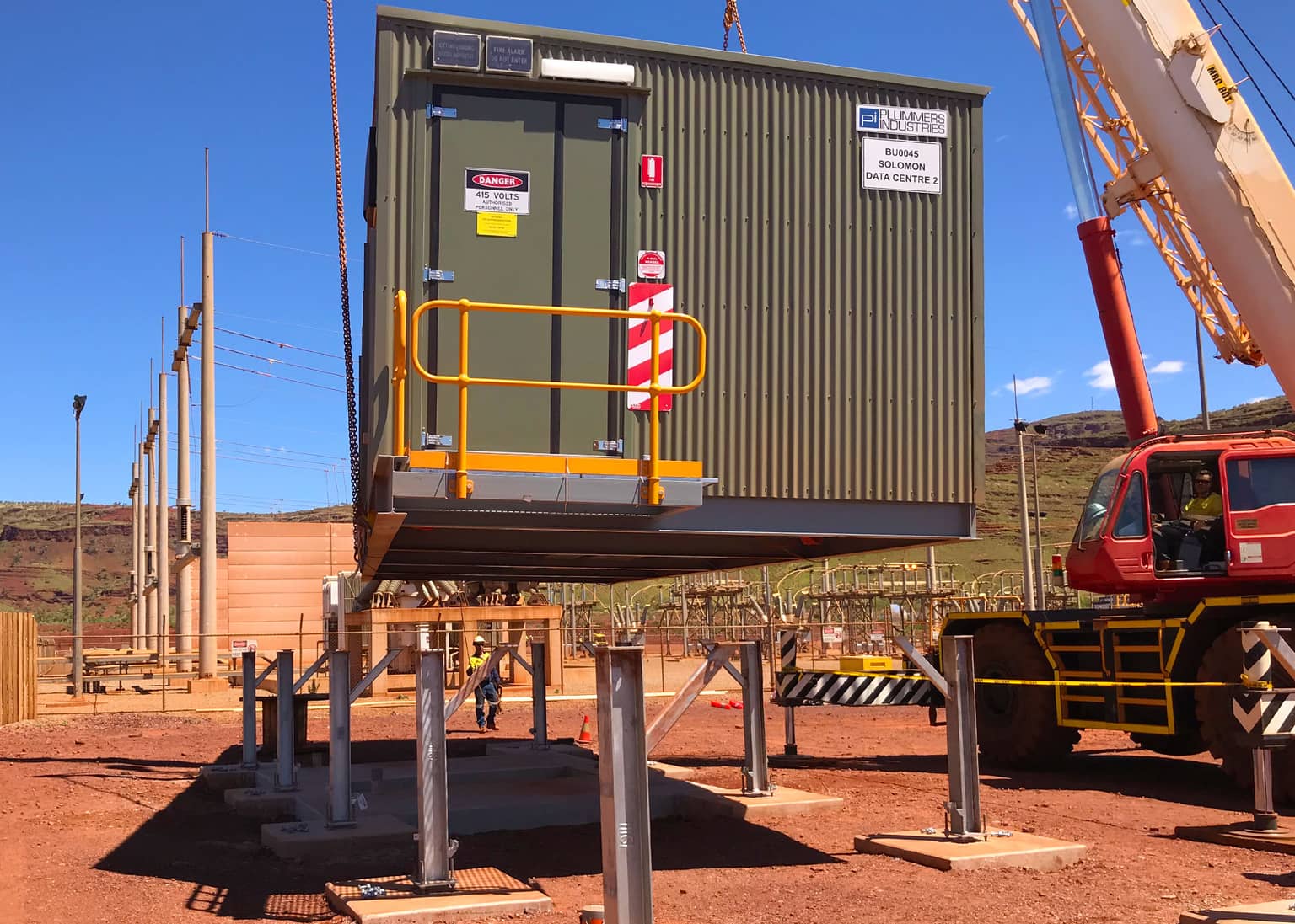Crane lowering the data centre module onto its steel footings